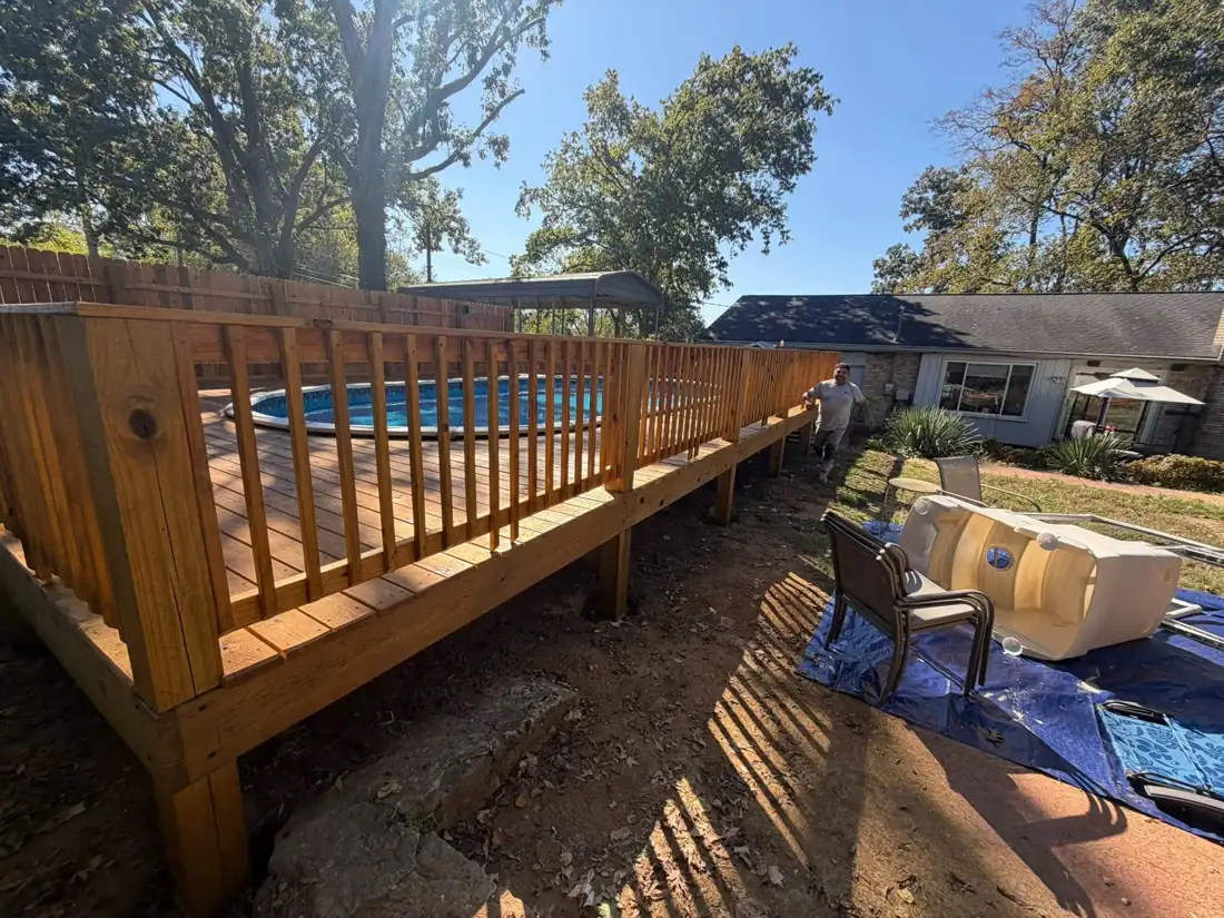 Stained deck railing around an above-ground pool